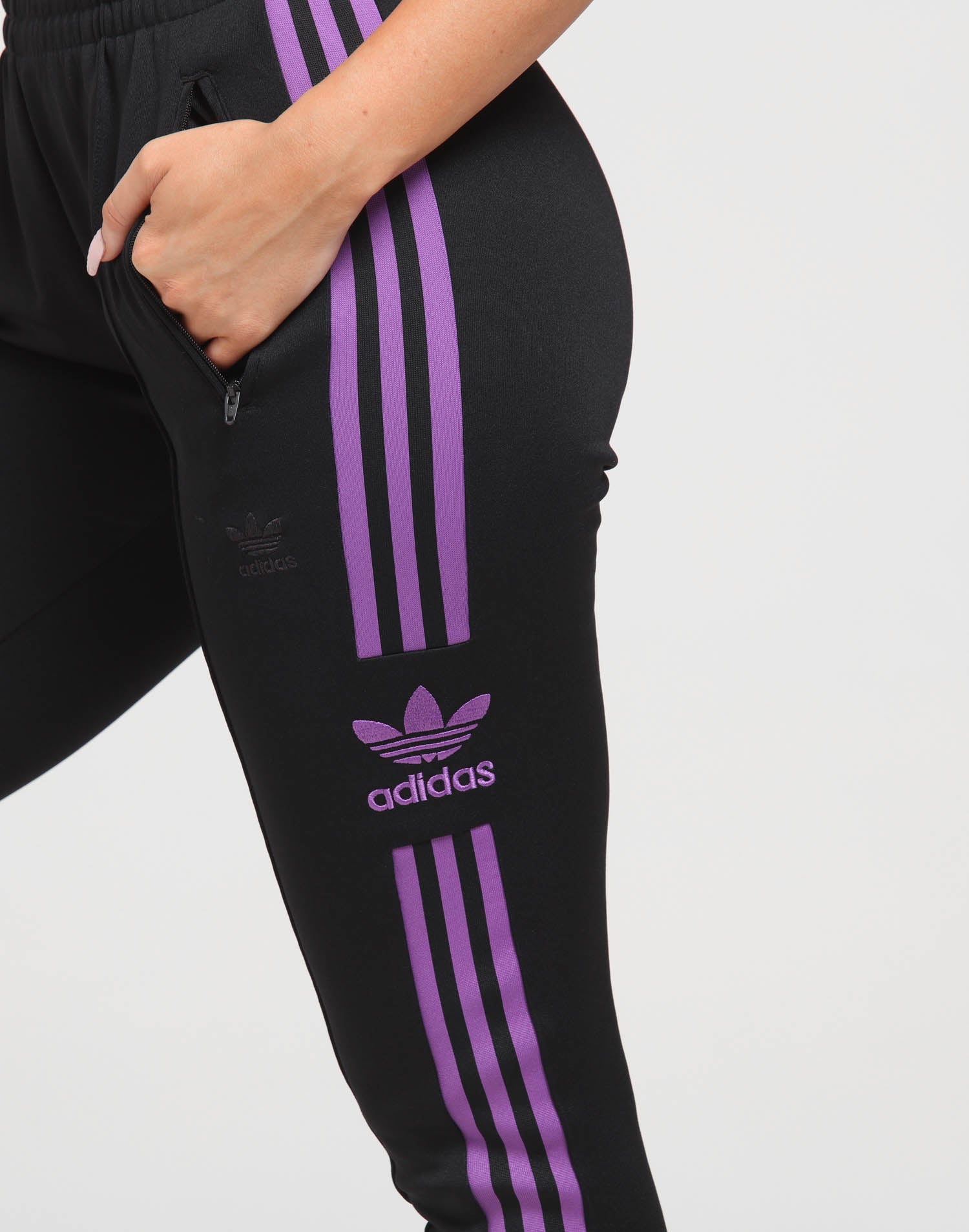 black adidas pants with purple stripes