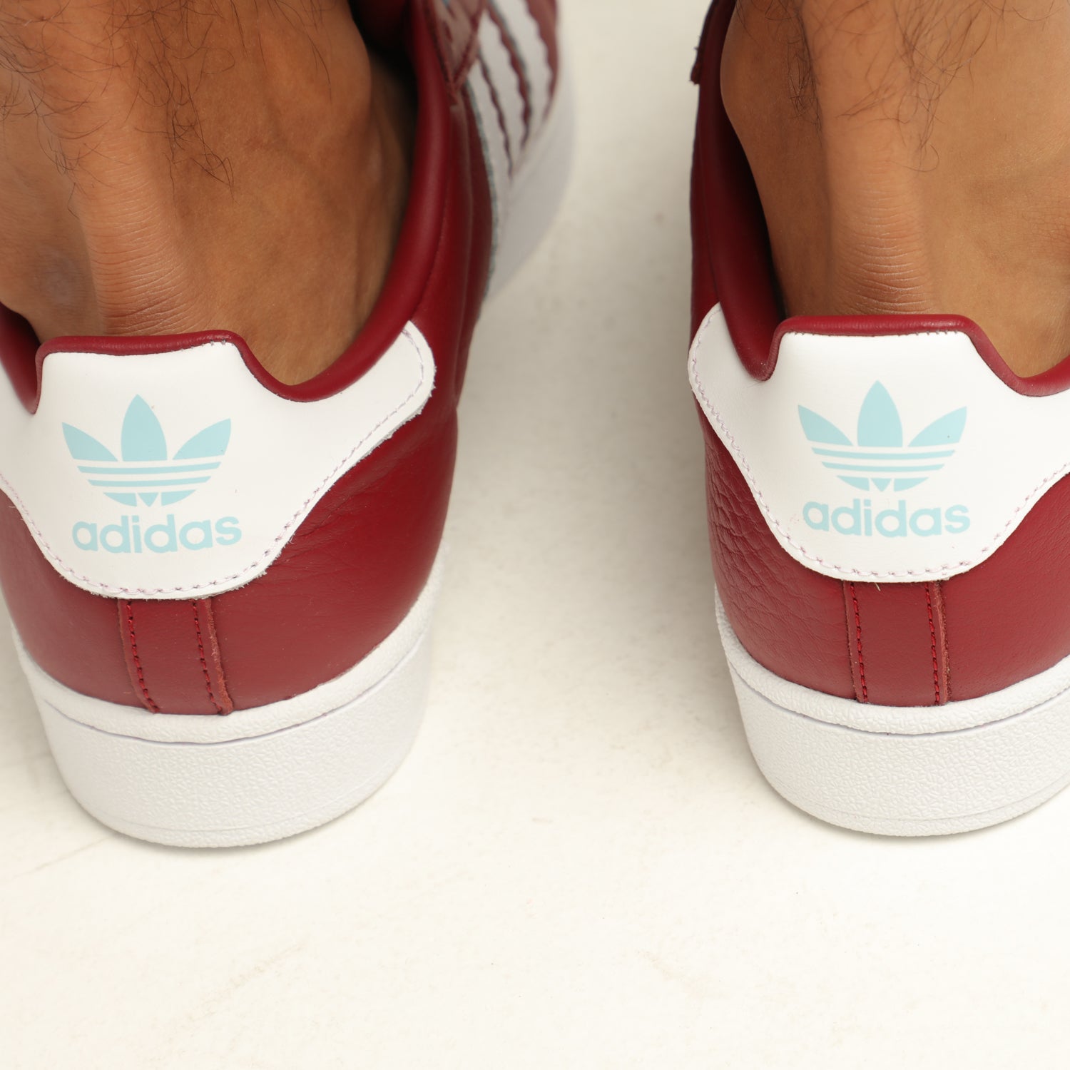 burgundy and white high top adidas