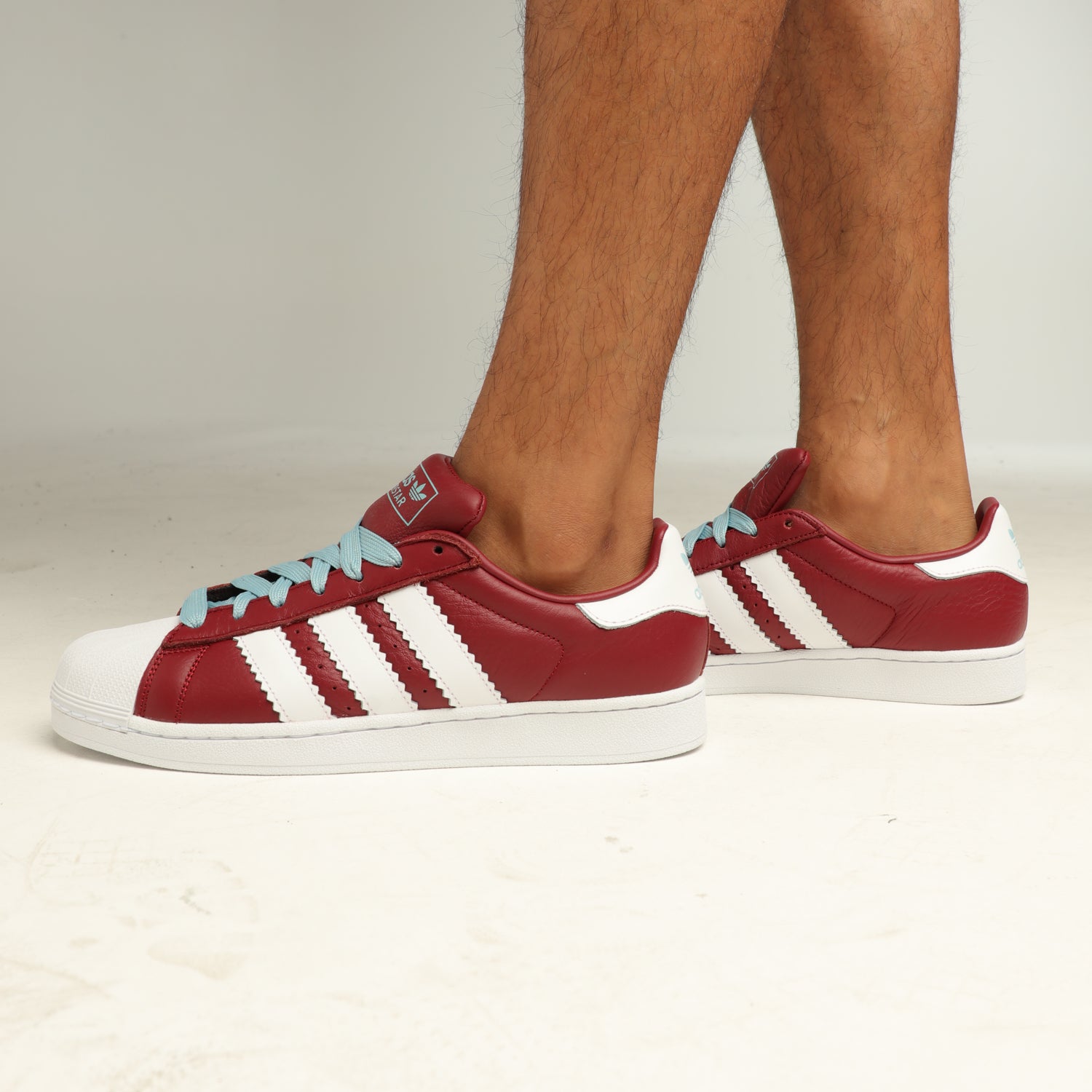 burgundy and white high top adidas