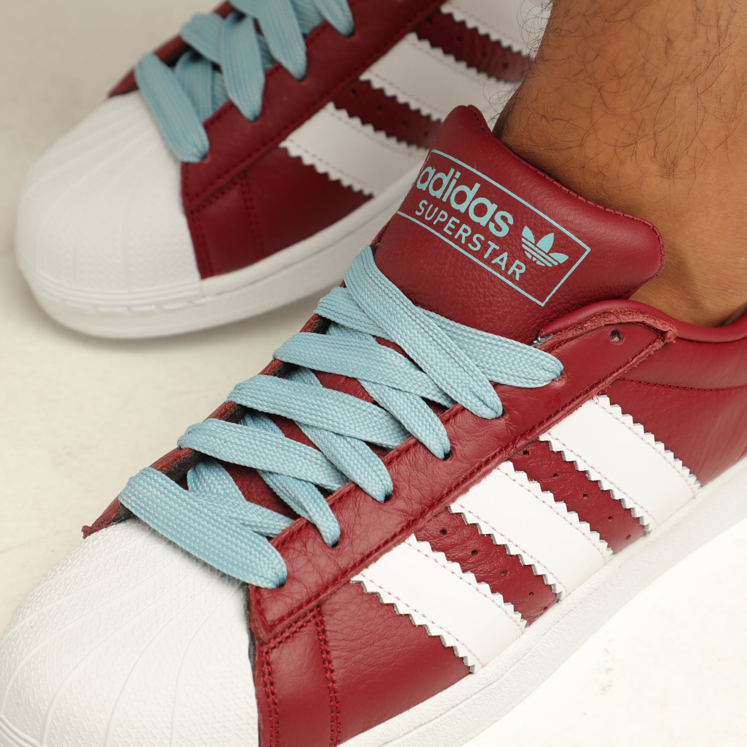 burgundy and white high top adidas