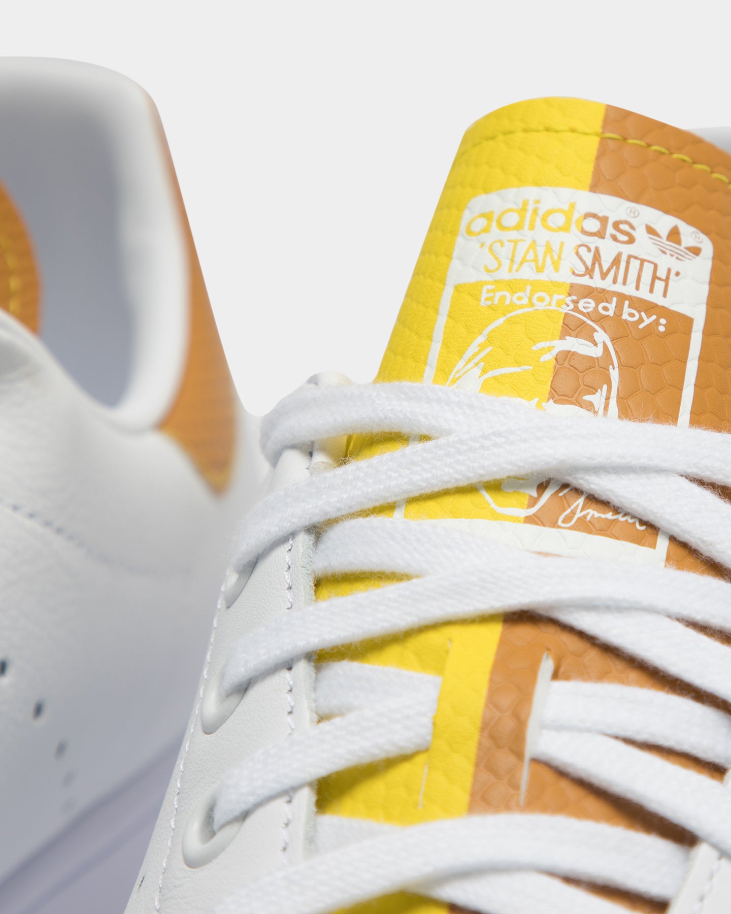 white and yellow stan smith