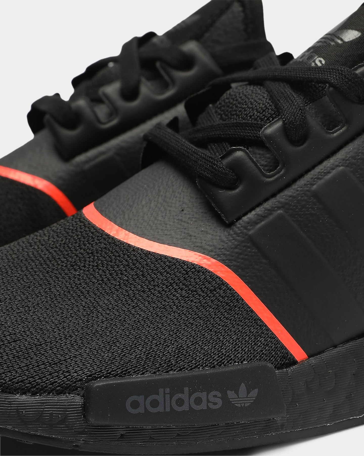 adidas nmd black with red bottom