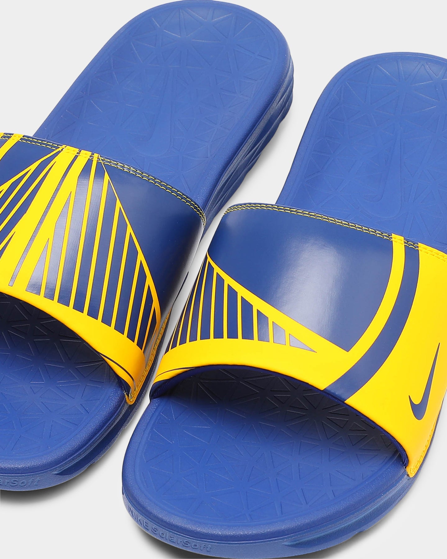 blue and yellow nike slides